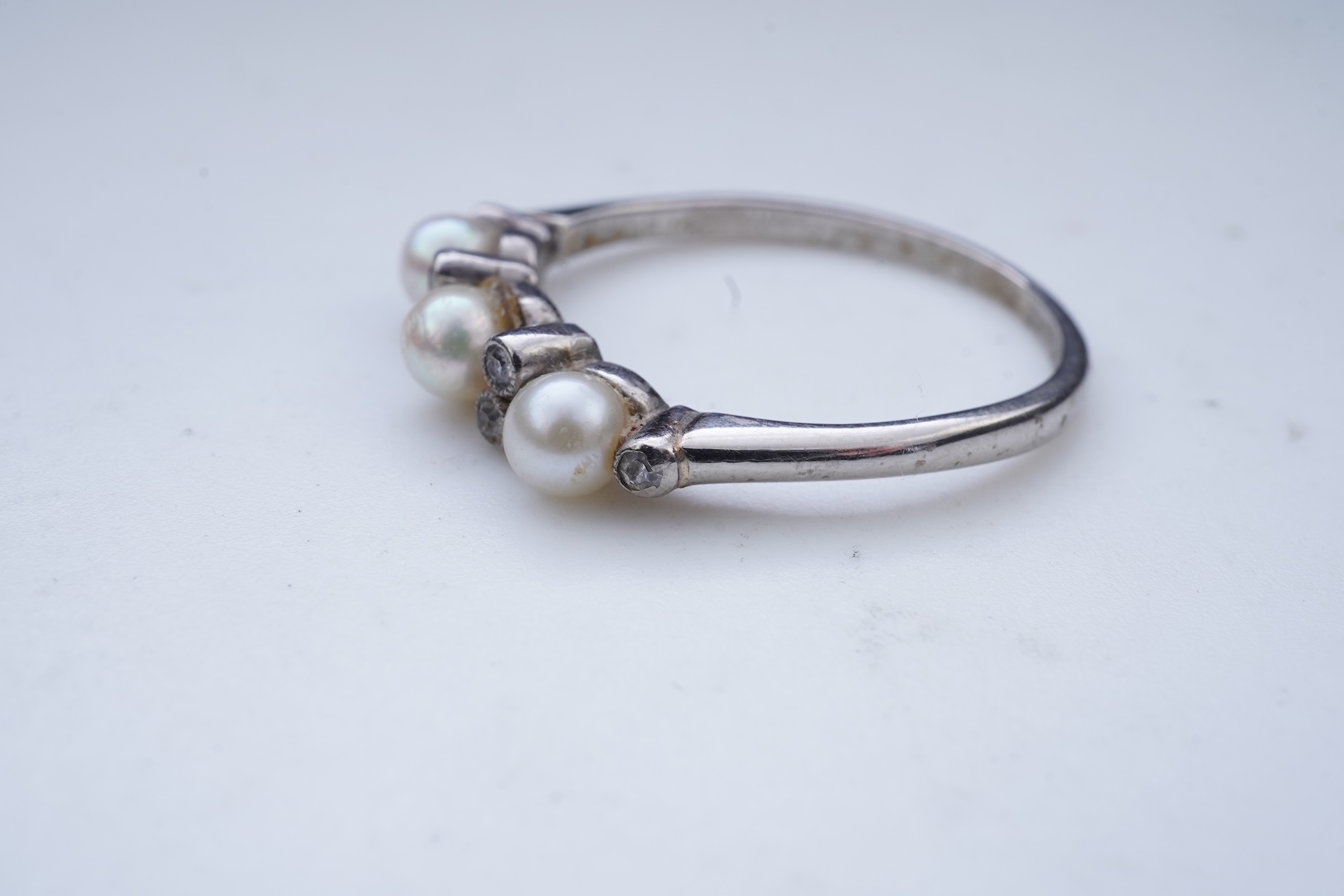 An Edwardian seed pearl brooch and a pearl and diamond ring